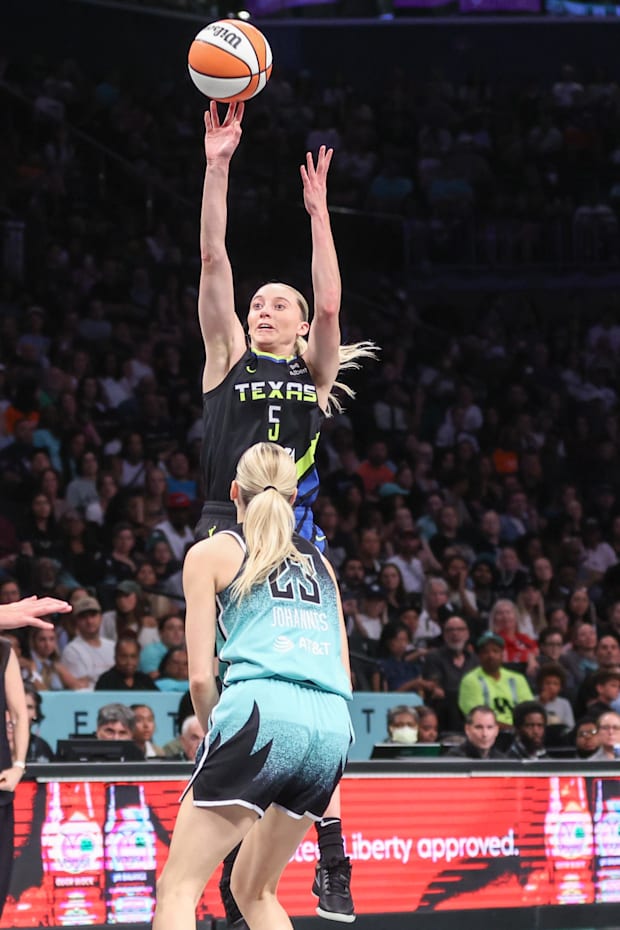 Dallas Wings guard Paige Bueckers takes a three point shot past New York Liberty guard Marine Johannes