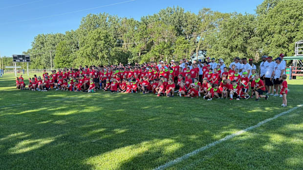 Participants and coaches pose for a picture at the Carriker Chronicles Football Camp.