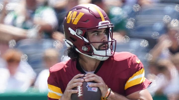 Aug 10, 2024; East Rutherford, New Jersey, USA; Washington Commanders quarterback Sam Hartman (11) looks downfield during the first half against the New York Jets at MetLife Stadium. Mandatory Credit: Lucas Boland-USA TODAY Sports