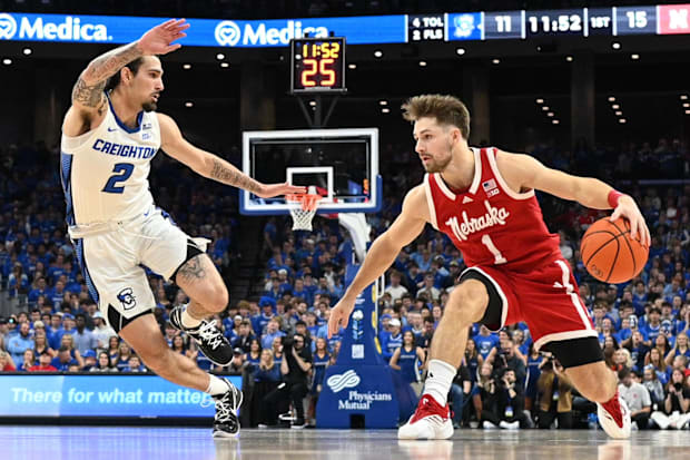 Nebraska guard Sam Hoiberg dribbles against Creighton guard Pop Isaacs on Nov. 22, 2024
