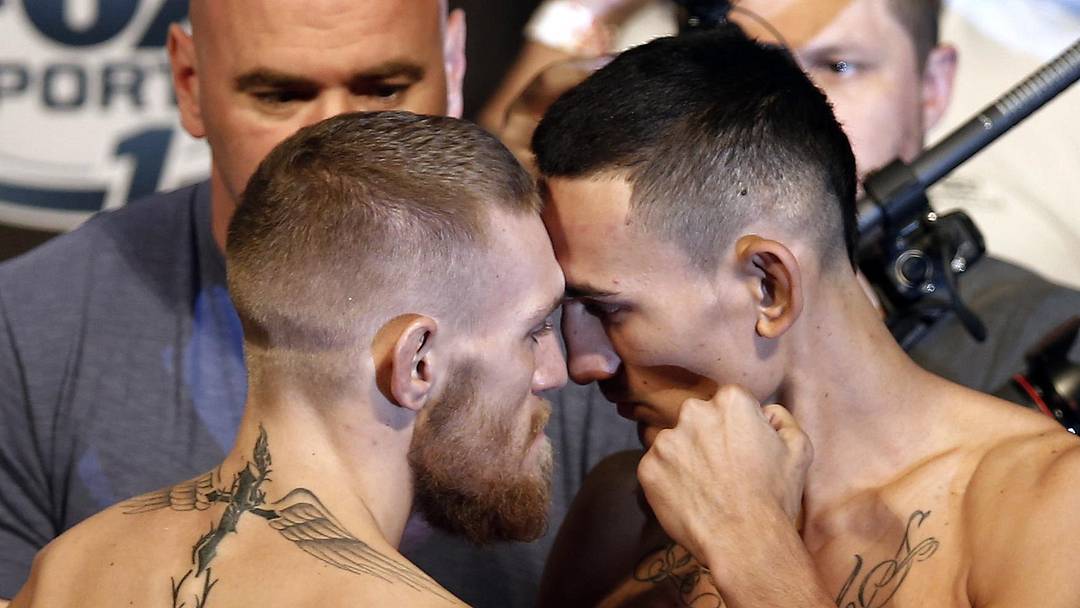 Aug 16, 2013; Boston, MA, USA; Conor McGregor (left) poses with Max Holloway during the weigh-in for their UFC fight at TD Garden tomorrow night. Mandatory Credit: Winslow Townson-Imagn Images