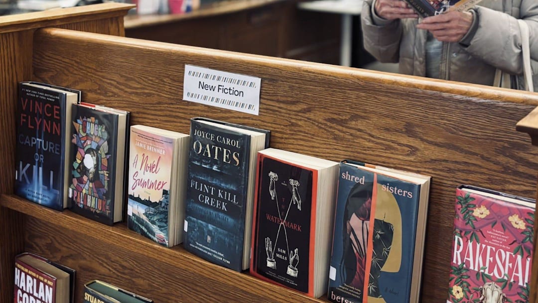 Jane Fitzpatrick, of Wells, Maine, looks through a book at the Kennebunk Free Library on April 2, 2025.