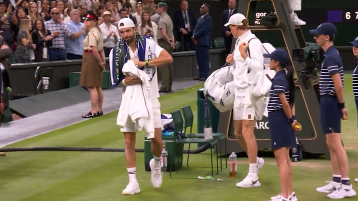 Grigor Dimitrov and Jannik Sinner leave centre court at Wimbledon after Dimitrov retired from their Round of 16 match due to an injury.