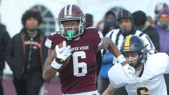 Harper Woods receiver Dakota Guerrant runs by Airport High School Colin Nowak for a touchdown during first half action at Harper Woods High School at Harper Woods High School on Saturday, Nov 11, 2023.