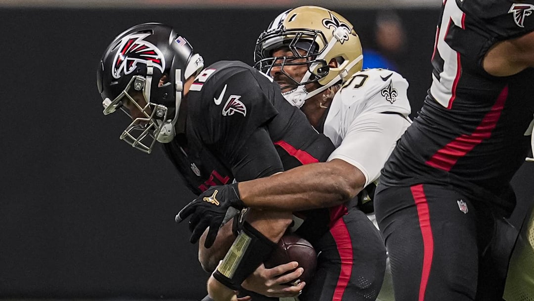 Jan 4, 2026; Atlanta, Georgia, USA; Atlanta Falcons quarterback Kirk Cousins (18) is tackled for a loss by New Orleans Saints defensive end Cameron Jordan (94) during the first quarter at Mercedes-Benz Stadium. Mandatory Credit: Dale Zanine-Imagn Images