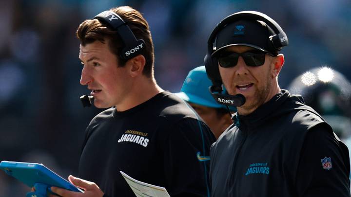 Jacksonville Jaguars offensive coordinator Grant Udinski, left listens on the headset as Jacksonville Jaguars head coach Liam Coen call a play during the first quarter in an NFL football AFC Wild Card playoff matchup, Sunday, Jan. 11, 2026, in Jacksonville, Fla. Bills lead 10-7 at the half over the Jaguars. 