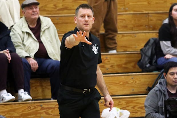Sherwood coach Rahim Tufts directs the action in the Bowmen’s Pacific Conference title-clinching 62-48 win at Century.