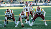 John McGregor (center) helped Central Catholic win the 6A football championship in 2023.