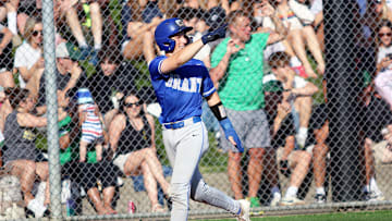 Grant junior Elliot Raiton points back at senior Kaeden Cruse, who is rounding the bases after his second home run in the Generals’ 8-2 semifinal victory at Jesuit.
