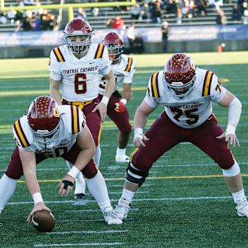 John McGregor (center) helped Central Catholic win the 6A football championship in 2023.