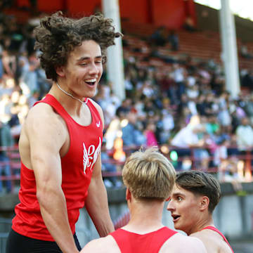 Oregon City’s (from left) Keaton Moore, Easton Hunt and Colin Smith celebrate after the Pioneers’ 4x100-meter state-record run of 41.00 seconds at the Three Rivers League district championships.