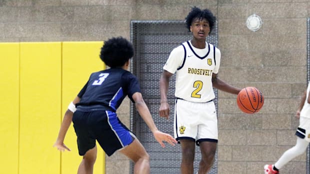 Roosevelt junior Fuzzy Montague brings the ball up court against Grant senior Zhalei Van during Saturday’s game.