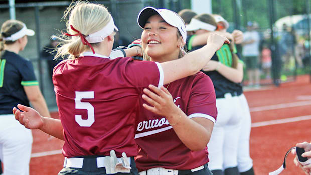 Sherwood senior Camryn Knight (left) hugs senior Destiny Cornwell following the 3-1 victory against West Linn.