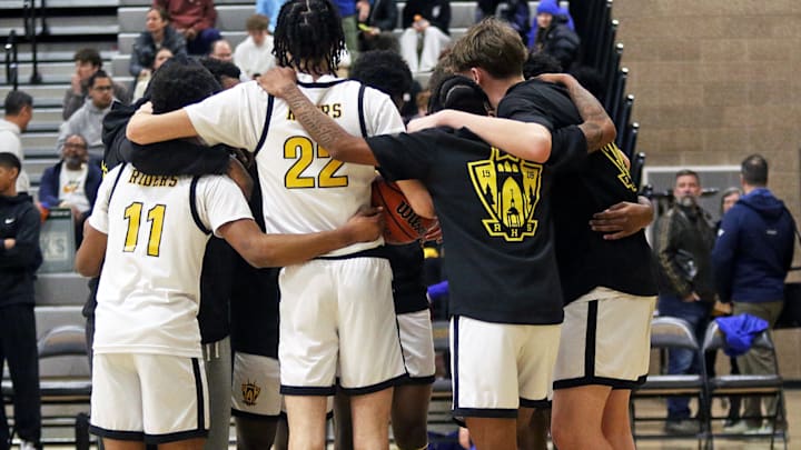 Members of the Roosevelt boys basketball team gather before the start of their Portland Interscholastic League showdown with Grant.