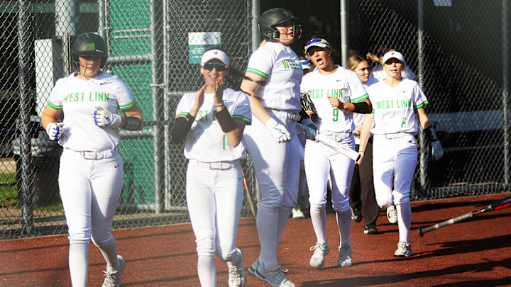 West Linn’s (from left), Avery Wolf, Kendall Atwood, Piper Ruthraugg, Emily Sakys and Maddie Brooke come out to greet Meg Allen at home plate after her third-inning home run in the 9-4 win over Tualatin West Linn’s (from left), Avery Wolf, Kendall Atwood, Piper Ruthraugg, Emily Sakys and Maddie Brooke come out to greet Meg Allen at home plate after her third-inning home run in the 9-4 win over Tualatin