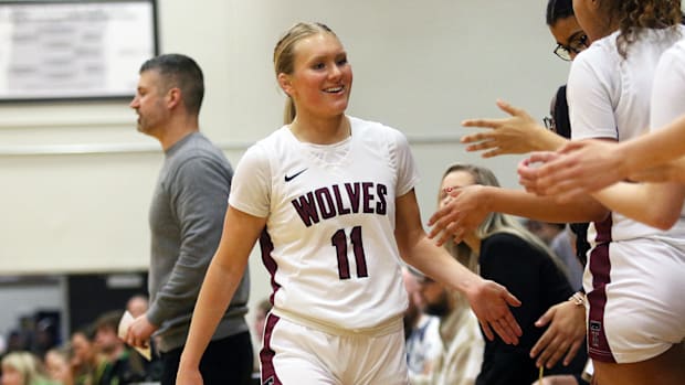 Tualatin junior Ries Miadich is congratulated by her teammates during the Timberwolves’ 55-30 victory against West Linn.