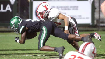 Immokalee linebacker Juan Cuevas (23) tackles a Venice ball carrier to the turf during a 2023 Southwest Florida high school football game.