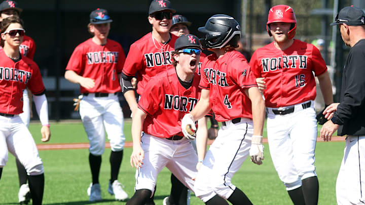 North Medford senior Colton Miller (4) is mobbed by his teammates after his walk-off RBI single in the bottom of the eighth inning of the Black Tornado’s 4-3 win over Aloha. North Medford senior Colton Miller (4) is mobbed by his teammates after his walk-off RBI single in the bottom of the eighth inning of the Black Tornado’s 4-3 win over Aloha.
