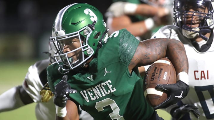 Venice running back Jamarice Wilder (3) rushes for a huge gain against the defense of Clearwater AI during Friday night football action in Venice. MATT HOUSTON/HERALD-TRIBUNE