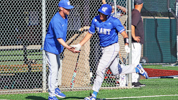 Grant senior Kaeden Cruse shakes hands with Generals coach Matt Kabza as he rounds the bases following his second home run during the 8-2 state semifinal win at Jesuit.