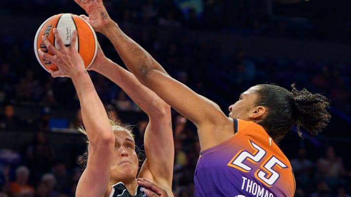 Sep 14, 2025; Phoenix, Arizona, USA; Phoenix Mercury forward Alyssa Thomas (25) reaches out to block New York Liberty forward Leonie Fiebich (13) in the first half during game one of the 2025 WNBA Playoffs round one at PHX Arena. Mandatory Credit: Allan Henry-Imagn Images