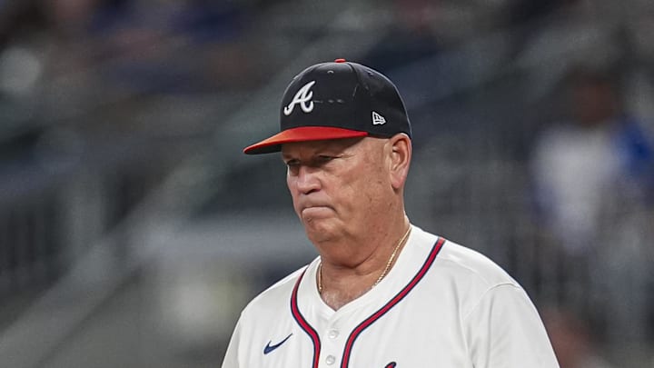 Sep 9, 2024; Cumberland, Georgia, USA; Atlanta Braves manager Brian Snitker (43) walks to the mound to change pitchers against the Cincinnati Reds during the seventh inning at Truist Park. Mandatory Credit: Dale Zanine-Imagn Images