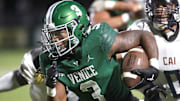 Venice running back Jamarice Wilder (3) rushes for a huge gain against the defense of Clearwater AI during Friday night football action in Venice. 