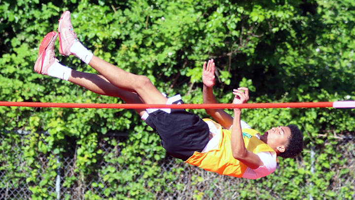 West Linn senior Warren Stanton clears a personal-best height of 6 feet, 6 inches during the boys high jump competition at the Three Rivers League district track and field championships.