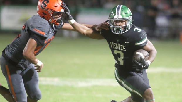 Venice running back Jamarice Wilder gets an edge on Sarasota's Brian Klingel during a game last season.