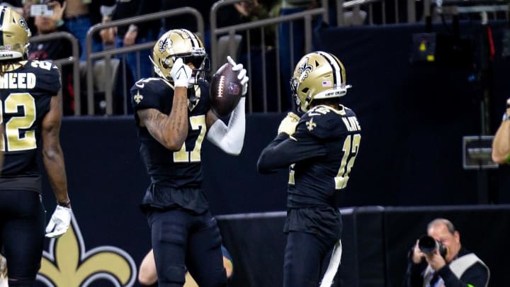 Jan 7, 2024; New Orleans, Louisiana, USA;  New Orleans Saints wide receiver A.T. Perry (17) celebrates a touchdown with wide receiver Chris Olave (12) against the Atlanta Falcons during the first half at Caesars Superdome. Mandatory Credit: Stephen Lew-USA TODAY Sports