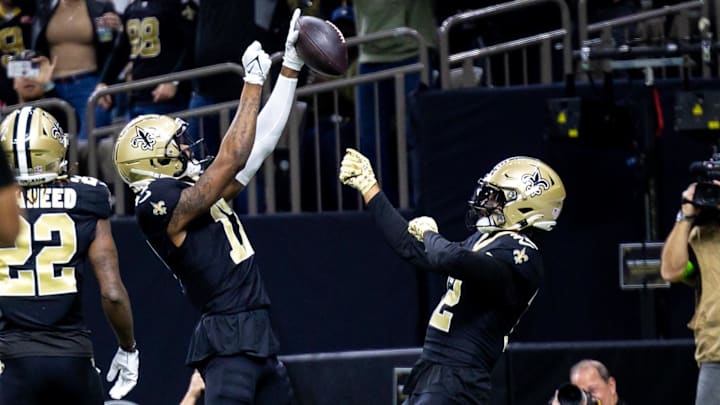 Jan 7, 2024; New Orleans, Louisiana, USA;  New Orleans Saints wide receiver A.T. Perry (17) celebrates a touchdown with wide receiver Chris Olave (12) against the Atlanta Falcons during the first half at Caesars Superdome. Mandatory Credit: Stephen Lew-Imagn Images