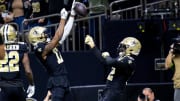 Jan 7, 2024; New Orleans, Louisiana, USA;  New Orleans Saints wide receiver A.T. Perry (17) celebrates a touchdown with wide receiver Chris Olave (12) against the Atlanta Falcons during the first half at Caesars Superdome. Mandatory Credit: Stephen Lew-USA TODAY Sports