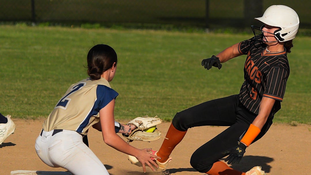 Sandalwood Saints Madison Seprish (2) outs Tocoi Creek Toros Ryleigh Williams (9) in the top of the second inning at Sandalwood High School in Jacksonville, Fla. Wednesday April 22, 2026. Tocoi Creek defeated Sandlewood 10-1.