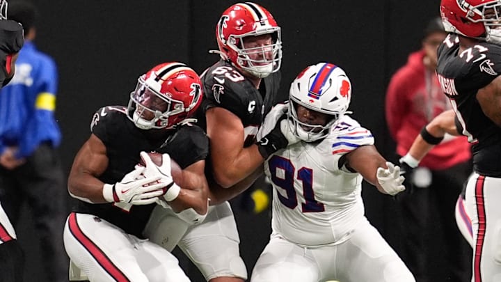 Oct 13, 2025; Atlanta, Georgia, USA; Atlanta Falcons running back Bijan Robinson (7) is tackled by. Buffalo Bills defensive tackle Ed Oliver (91) during the first half of a game at Mercedes-Benz Stadium. Mandatory Credit: Dale Zanine-Imagn Images