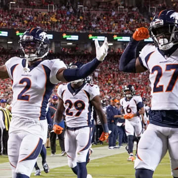 Oct 12, 2023; Kansas City, Missouri, USA; Denver Broncos safety Justin Simmons (31) and cornerback Pat Surtain II (2) and cornerback Damarri Mathis (27) celebrate after Simmon   s interception against the Kansas City Chiefs during the first half at GEHA Field at Arrowhead Stadium. Mandatory Credit: Denny Medley-USA TODAY Sports