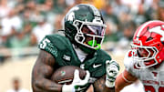 Michigan State's Makhi Frazier, left, runs for a touchdown as Youngstown State's Preston Zandier attempts the tackle during the second quarter on Saturday, Sept. 13, 2025, at Spartan Stadium in East Lansing.