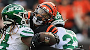 Oct 26, 2025; Cincinnati, Ohio, USA; Cincinnati Bengals wide receiver Andrei Iosivas (80) tries to escape attack from New York Jets linebacker Jamien Sherwood (44) and safety Tony Adams (22) during the fourth quarter at Paycor Stadium. Mandatory Credit: Katie Stratman-Imagn Images