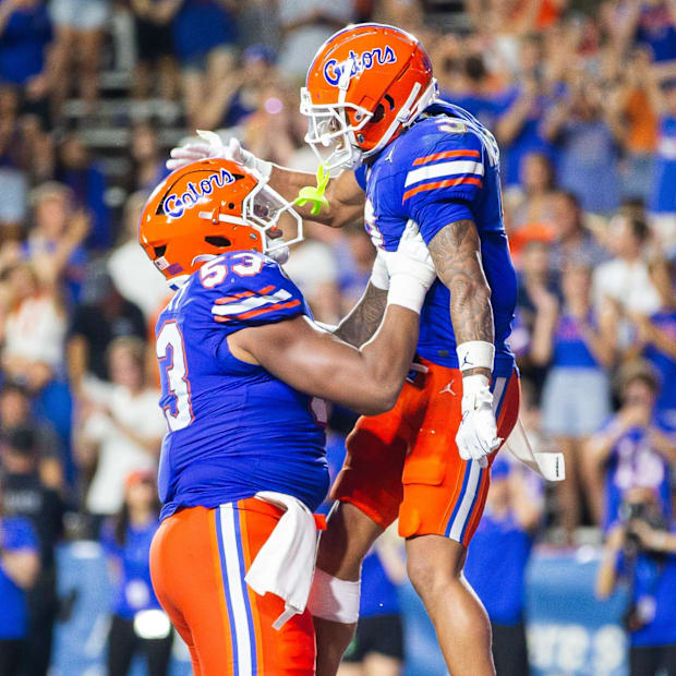 Florida Gators wide receiver Eugene Wilson III (3) celebrates his touchdown with a teammate.