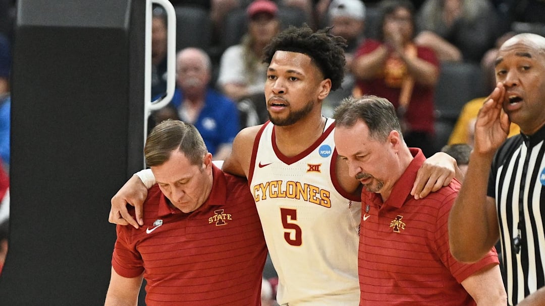 Mar 20, 2026; St. Louis, MO, USA; Iowa State Cyclones forward Joshua Jefferson (5) is helped off of the court after suffering an apparent injury to his left leg while shooting a layup against Tennessee State Tigers forward Jalen Pitre (not pictured) during the first half of a first round game of the men's 2026 NCAA Tournament at Enterprise Center. Mandatory Credit: Jeff Le-Imagn Images
