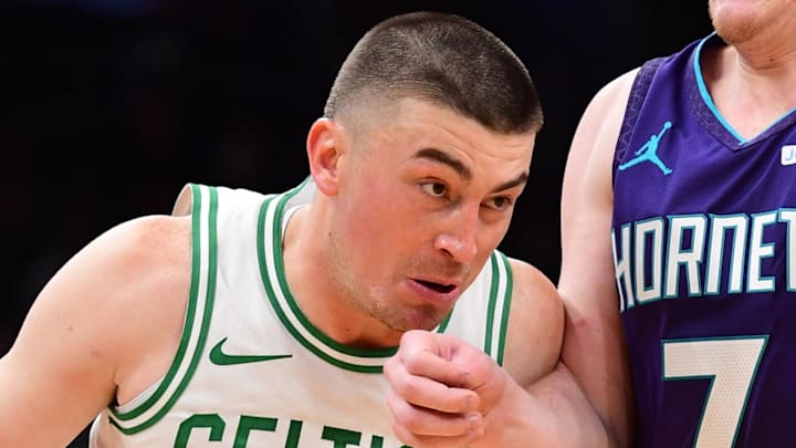 Mar 4, 2026; Boston, Massachusetts, USA;  Boston Celtics guard Payton Pritchard (11) drives to the basket while Charlotte Hornets guard Kon Knueppel (7) defends during the first half at TD Garden. Mandatory Credit: Bob DeChiara-Imagn Images