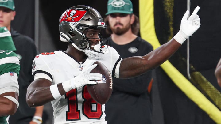 Aug 19, 2023; East Rutherford, New Jersey, USA; Tampa Bay Buccaneers wide receiver Rakim Jarrett (18) reacts after a first down in front of New York Jets safety Ashtyn Davis (21) during the second half at MetLife Stadium. Mandatory Credit: Vincent Carchietta-USA TODAY Sports
