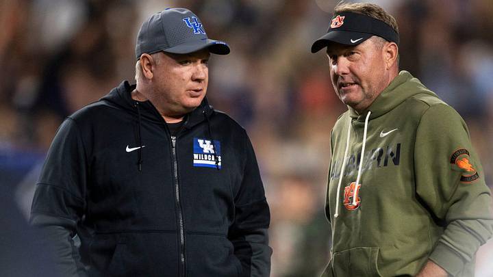 Kentucky Wildcats head coach Mark Stoops and Auburn Tigers head coach Hugh Freeze talk before Auburn Tigers take on Kentucky Wildcats in Auburn, Ala. on Saturday, Nov. 1, 2025.