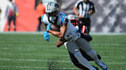 Sep 28, 2025; Foxborough, Massachusetts, USA; New England Patriots safety Jaylinn Hawkins (21) tackles Carolina Panthers wide receiver Tetairoa McMillan (4) during the first half at Gillette Stadium.