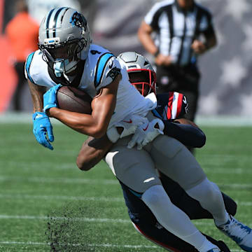 Sep 28, 2025; Foxborough, Massachusetts, USA; New England Patriots safety Jaylinn Hawkins (21) tackles Carolina Panthers wide receiver Tetairoa McMillan (4) during the first half at Gillette Stadium.
