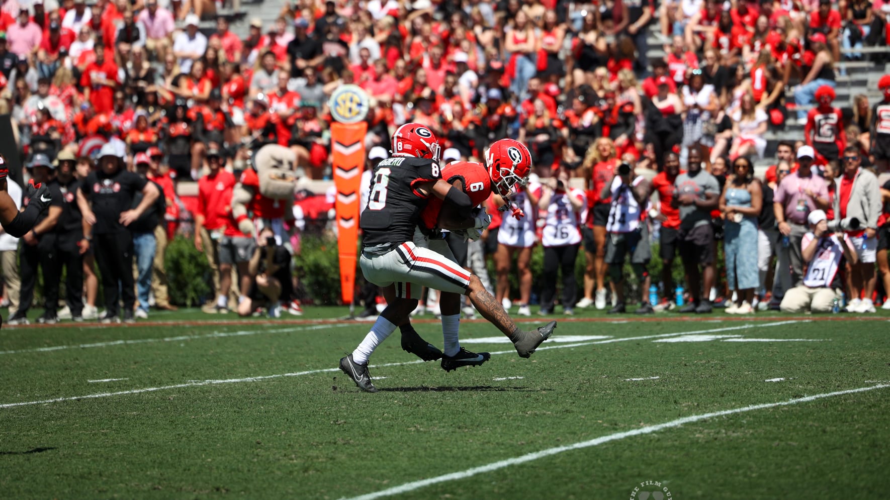 WR, Dominic Lovett carries a defender near the endzone. 
