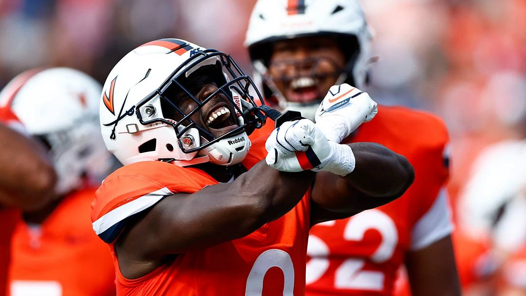 Xavier Brown scores a touchdown, and throws up the 'X' to celebrate.
