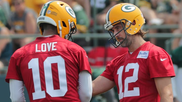 Green Bay Packers quarterback Aaron Rodgers (12) talks with quarterback Jordan Love (10) during the first day of training camp on July 28, 2021 in Green Bay, Wis.