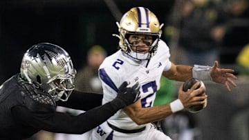 Oregon’s Jordan Burch, left, sacks Washington quarterback Demond Williams Jr. during the third quarter at Autzen Stadium in Eugene Saturday, Nov. 30, 2024