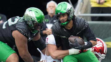 Oregon quarterback Dante Moore, right, is sacked on the opening drive of the game against Indiana at Autzen Stadium October 11, 2025.