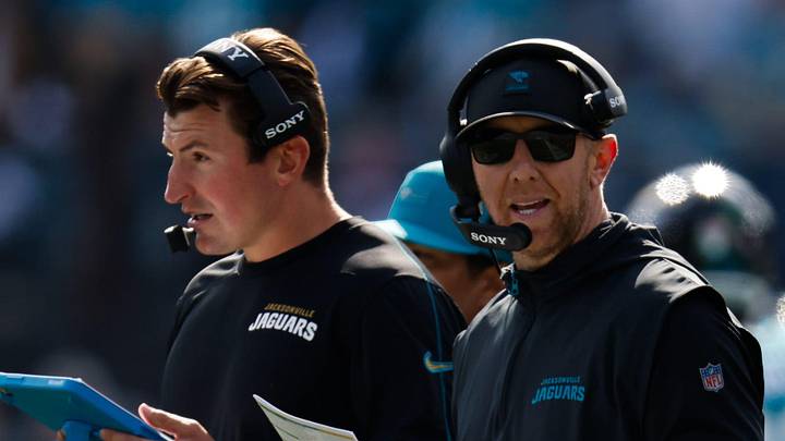 Jacksonville Jaguars offensive coordinator Grant Udinski, left listens on the headset as Jacksonville Jaguars head coach Liam Coen call a play during the first quarter in an NFL football AFC Wild Card playoff matchup, Sunday, Jan. 11, 2026, in Jacksonville, Fla. Bills lead 10-7 at the half over the Jaguars. 